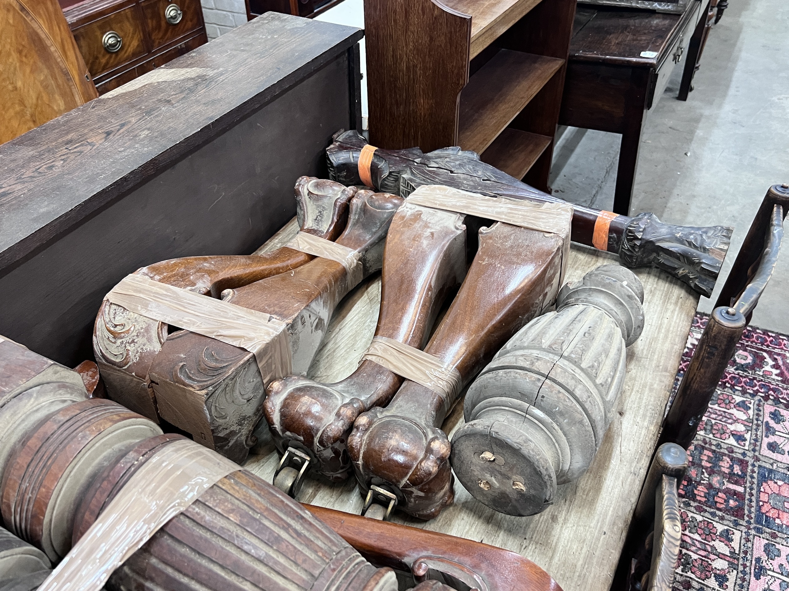 Seven sets of Victorian and later mahogany table legs, tallest 79cm